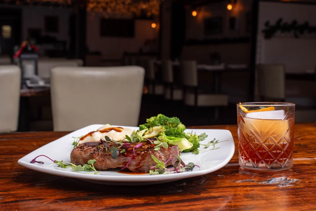 Cocktails and plated food arranged for a group dinner celebration