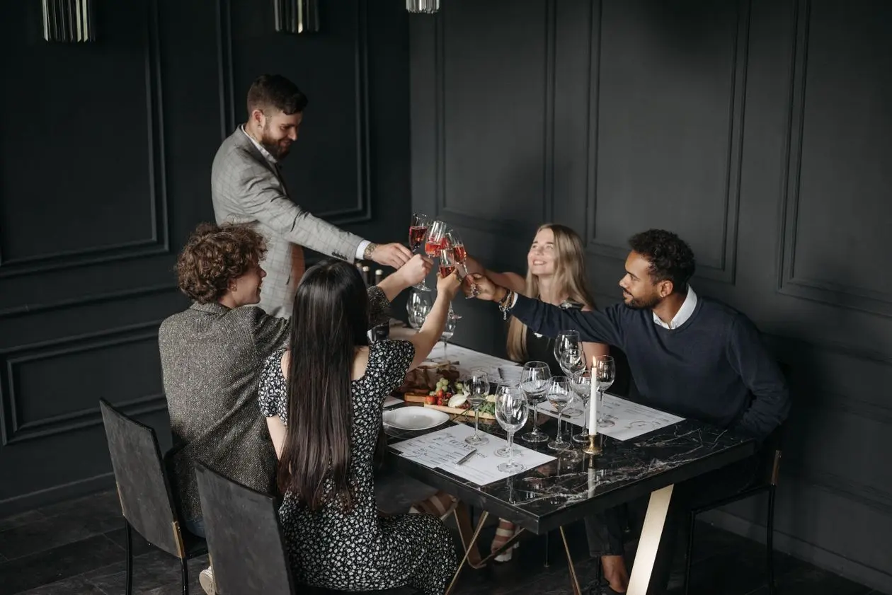 A toast with your friends is the heart of the evening. Photo by Pavel Danilyuk on Pexels.