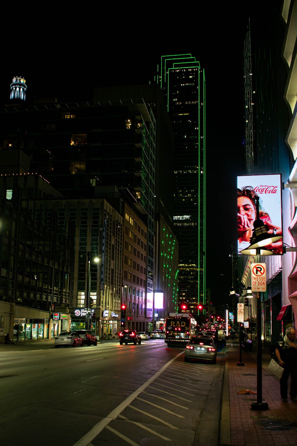 Downtown Dallas street at night with city lights
